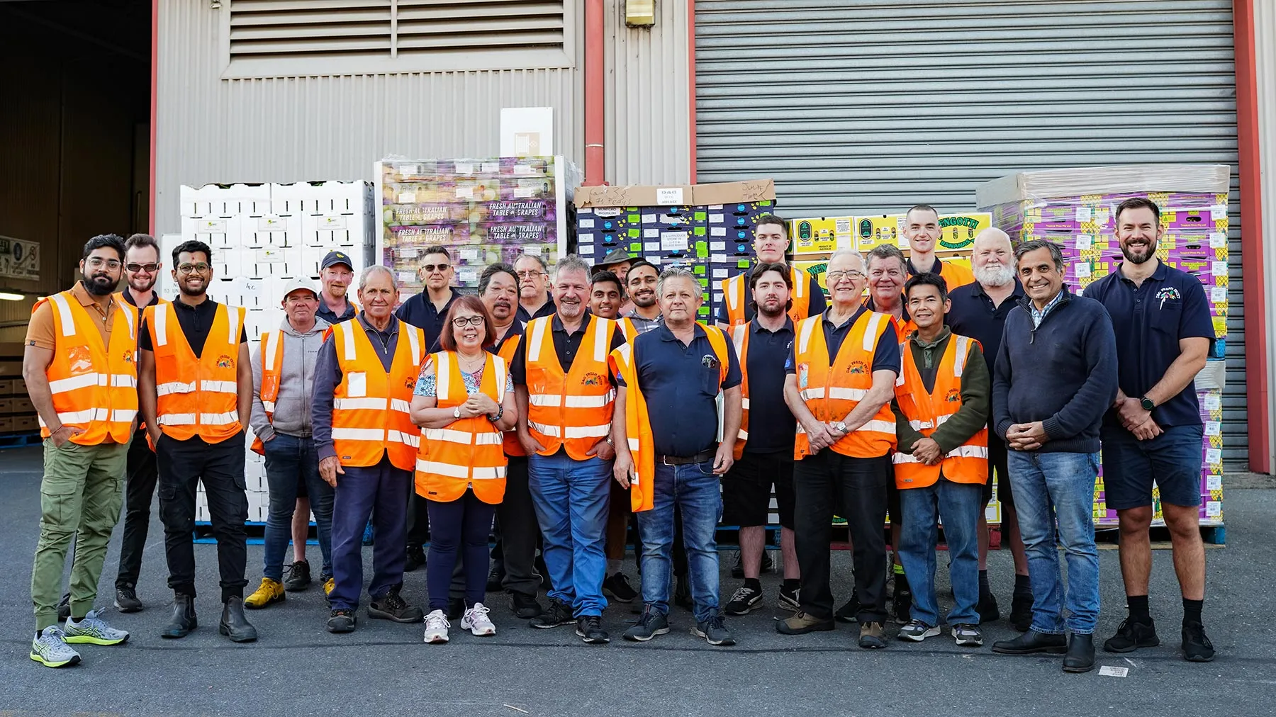 The D&G Fresh Fruit team in hi-vis vests outside their shed at the South Australian Produce Markets, Pooraka